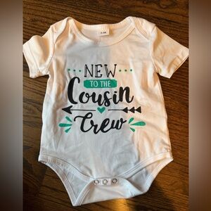 White Baby Onesie with Black and Green New to the Cousin CrewPrint